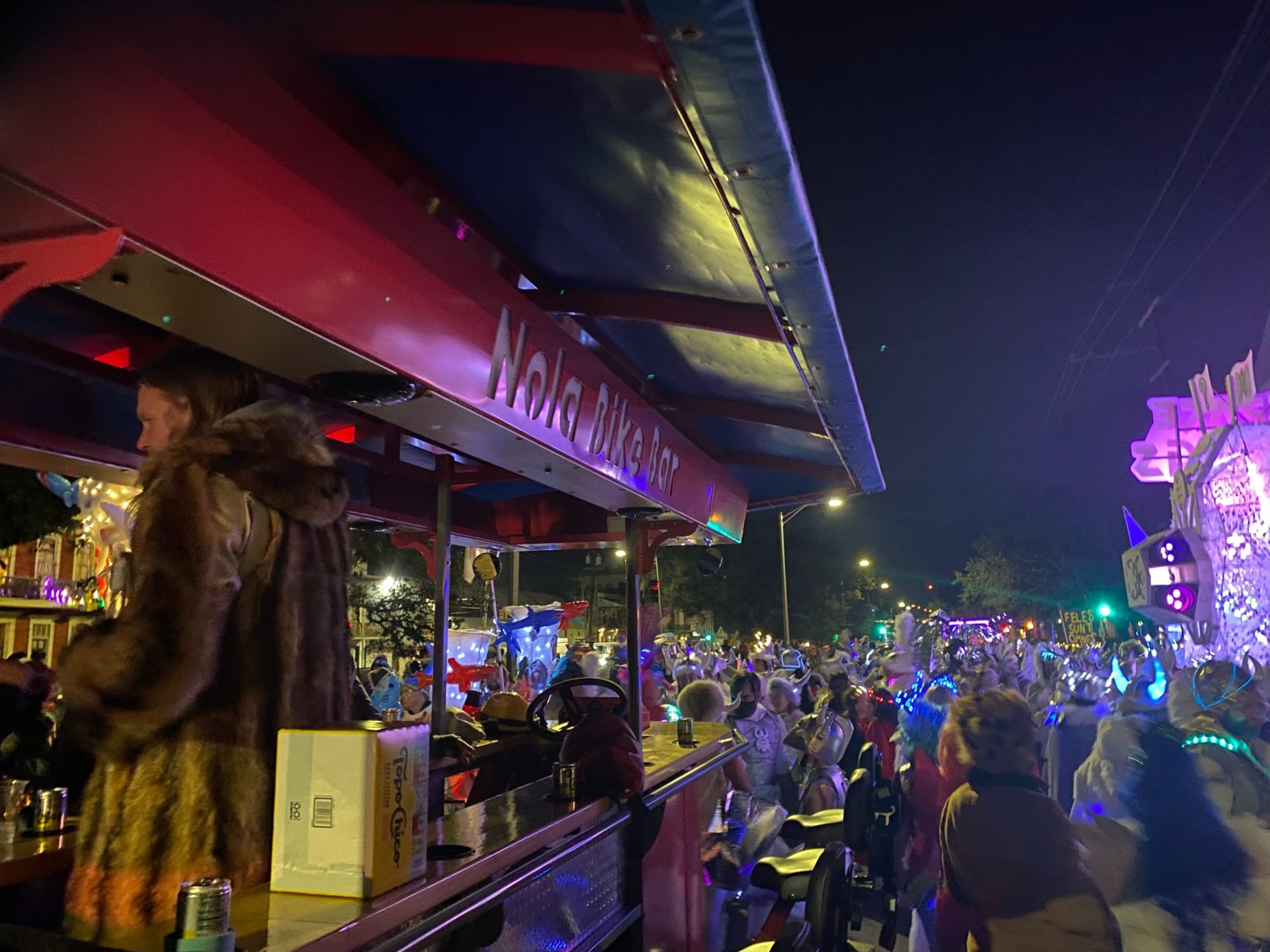 a crowd of people standing on a stage in front of a store