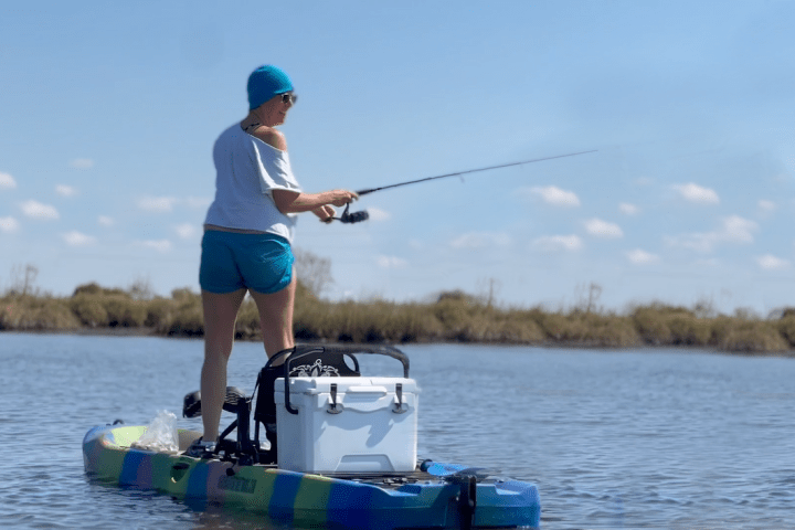 a person riding on the back of a boat in the water
