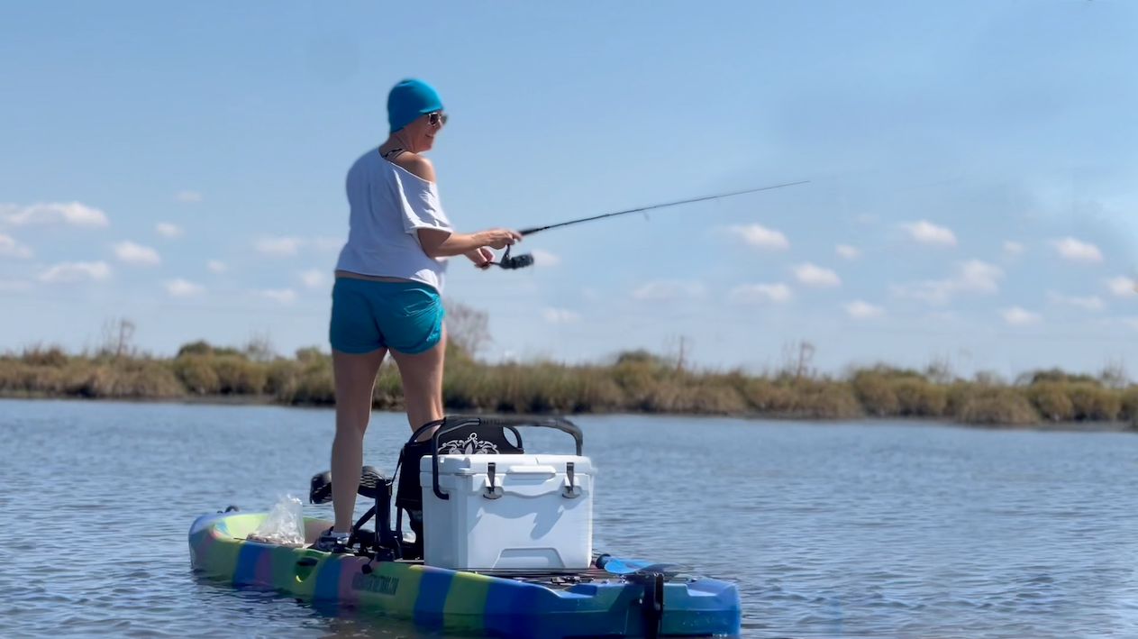 Hooked on the Bayou: New Orleans Kayak Fishing Charter Tour at Bayou Bienvenue Image 1 a person riding on the back of a boat in the water